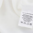 Fabric composition and washing instructions label on white shirt