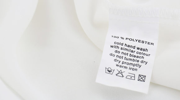 Fabric composition and washing instructions label on white shirt