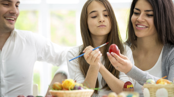 family together decorate eggs