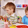 Children painting at easel.