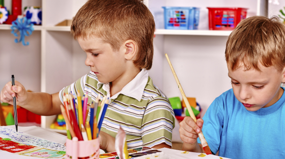 Children painting at easel.