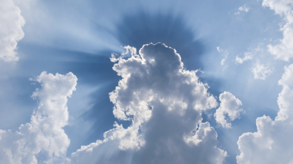 clouds in blue sky with sunrays