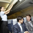 Photo of woman holding and giving glass of water to young businessman