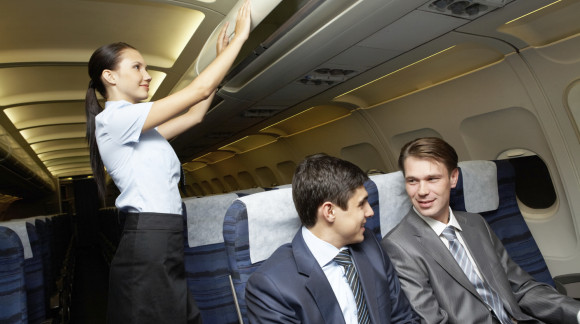 Photo of woman holding and giving glass of water to young businessman