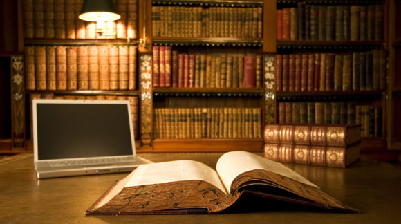 Laptop in classic library with books in background series