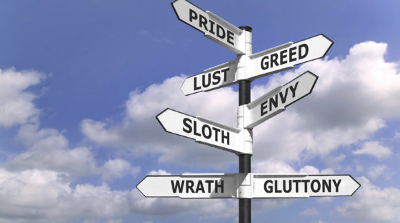 Concept image of a signpost with the seven deadly sins upon the arrows.