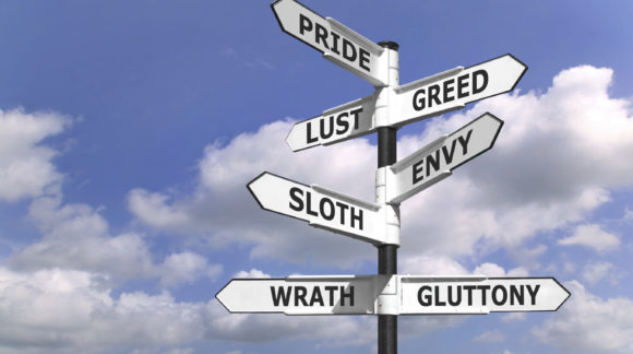 Concept image of a signpost with the seven deadly sins upon the arrows.