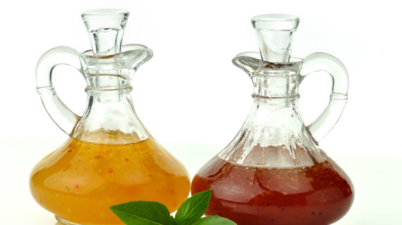 Bottles of salad dressing over a white background