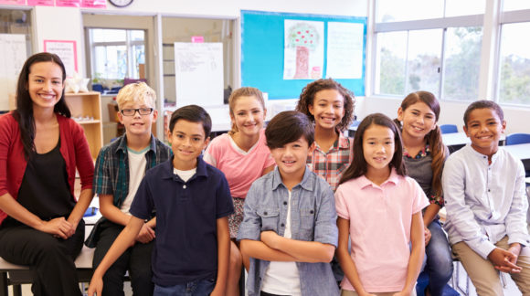 Elementary school teacher and her pupils in classroom